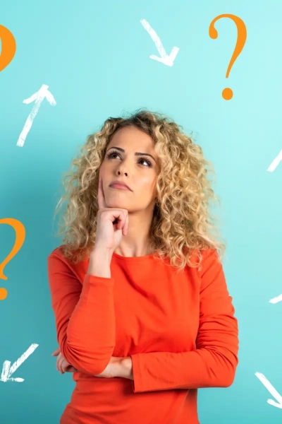 Confused and pensive expression of a black girl with many questions . cyan colored background